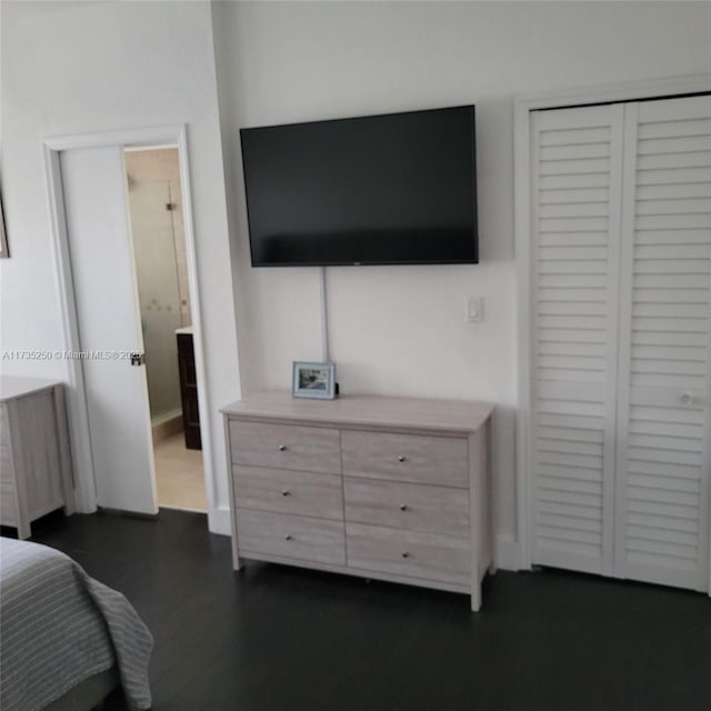 bedroom featuring radiator, dark hardwood / wood-style flooring, and a closet