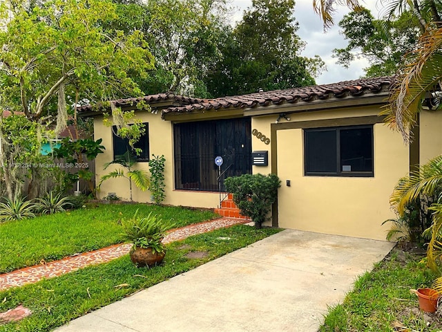 mediterranean / spanish house with a front yard