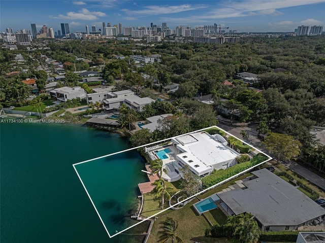 birds eye view of property with a water view