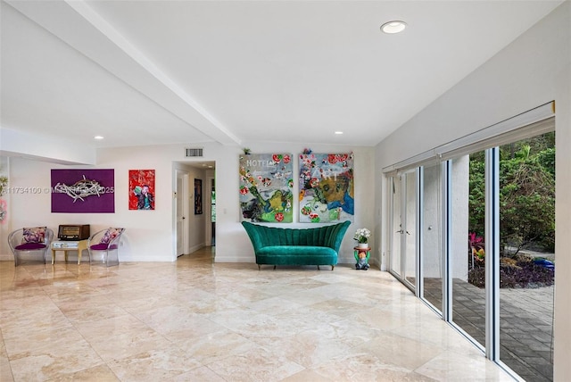 living area with beam ceiling