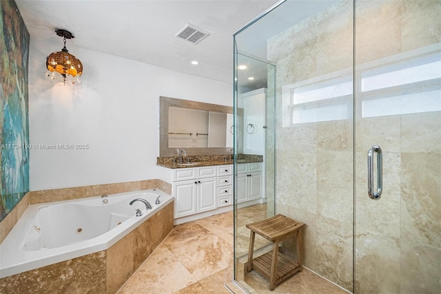 bathroom with vanity and shower with separate bathtub