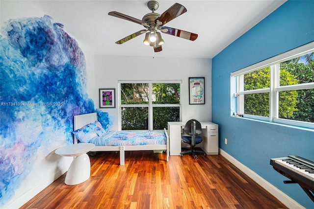 unfurnished bedroom featuring ceiling fan and dark hardwood / wood-style flooring