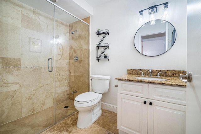 bathroom with vanity, tile patterned floors, a shower with door, and toilet