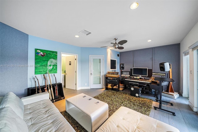 living room featuring ceiling fan and light wood-type flooring