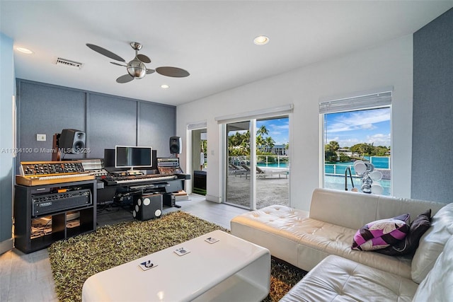 interior space with ceiling fan