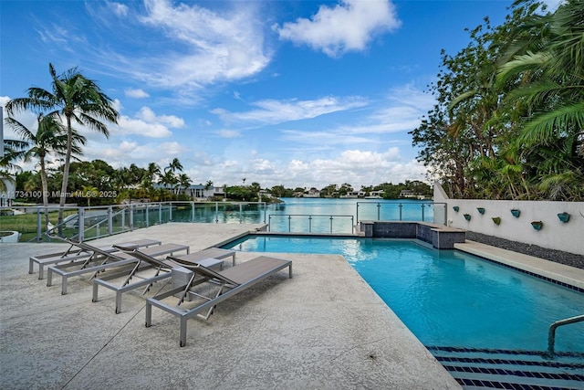 view of pool featuring a patio and a water view