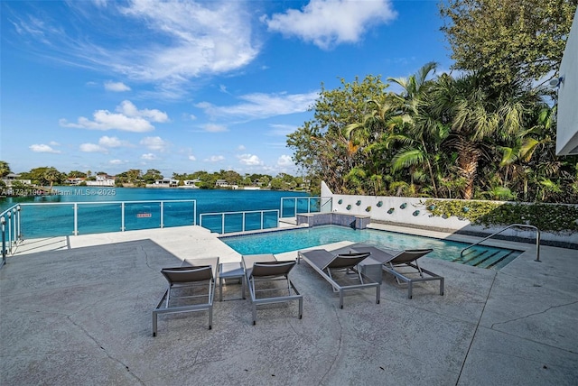 view of swimming pool featuring a water view and a patio area