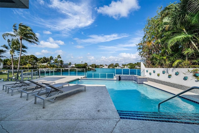 view of pool featuring a water view and a patio area