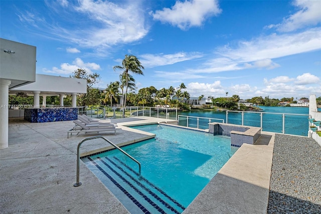 view of swimming pool featuring a water view and a patio