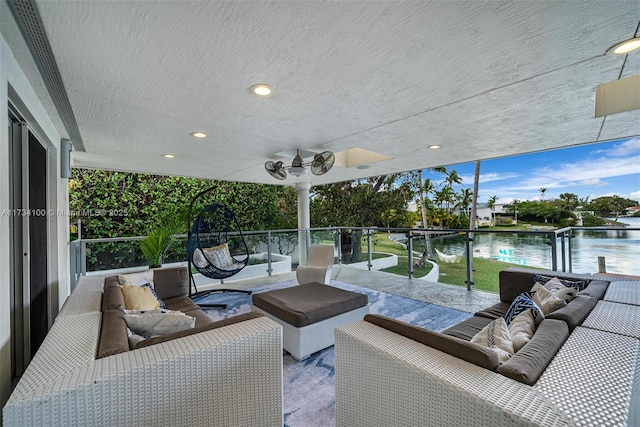 view of patio / terrace with a balcony, a water view, outdoor lounge area, and ceiling fan