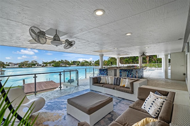 view of patio featuring outdoor lounge area, ceiling fan, and a water view