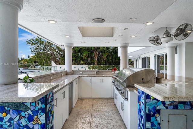 view of patio / terrace featuring exterior kitchen, a grill, and an outdoor wet bar