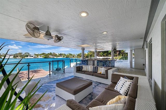 view of patio / terrace featuring a water view, ceiling fan, and an outdoor hangout area