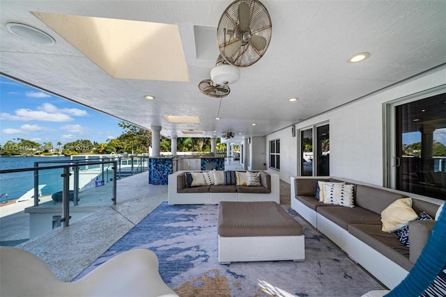 view of patio featuring a water view, a balcony, and outdoor lounge area