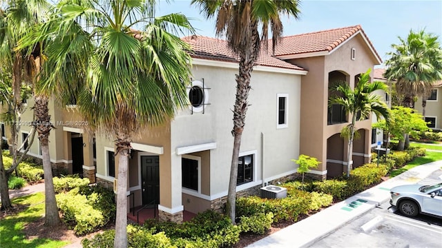 22411 SW 88th Pl Unit 16-26, Cutler Bay, FL 33190 - view of building exterior featuring uncovered parking and central AC