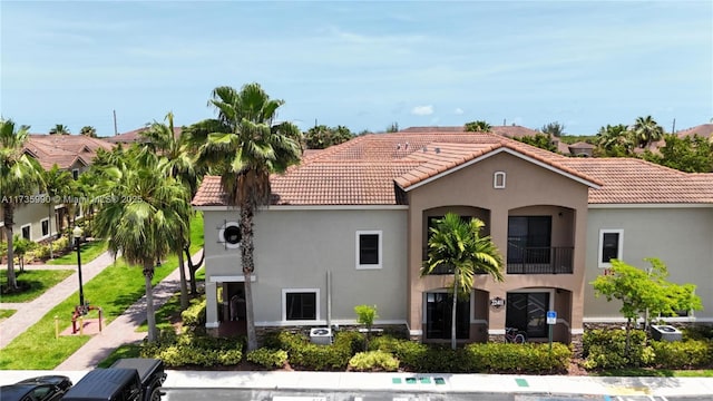 22411 SW 88th Pl Unit 16-26, Cutler Bay, FL 33190 - view of front of property with a tile roof, stucco siding, and a balcony