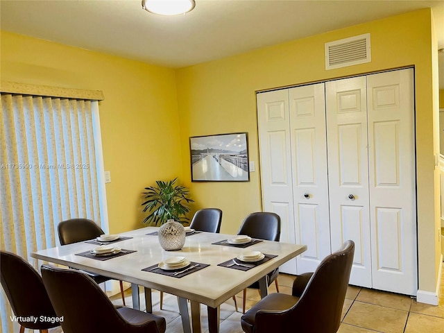 dining area with light tile patterned floors and visible vents