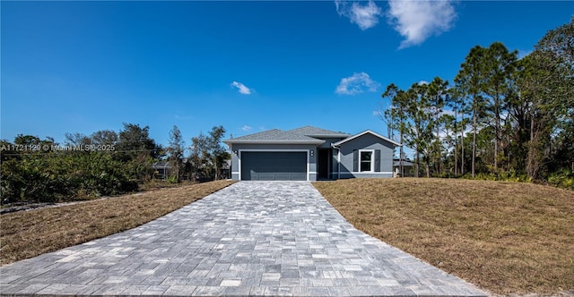 view of front of house with a garage and a front lawn