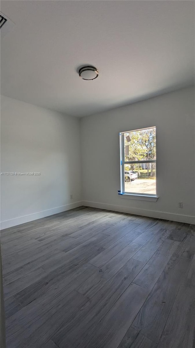 unfurnished room with dark hardwood / wood-style floors