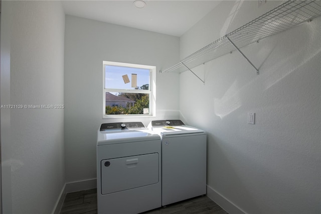 washroom featuring dark hardwood / wood-style floors and washing machine and dryer