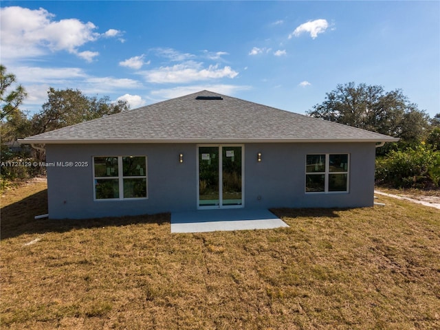 rear view of property with a patio area and a lawn