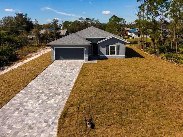 view of front of property with a garage and a front lawn