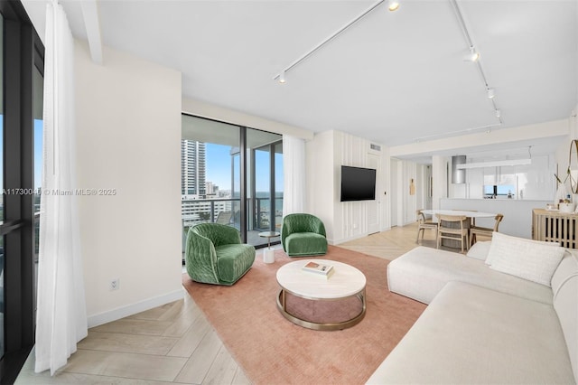 2201 Collins Ave Unit 1128, Miami Beach, FL 33139 - living area featuring rail lighting and baseboards