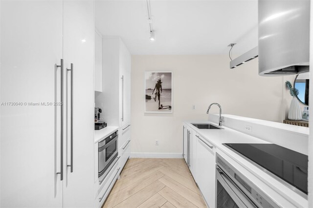2201 Collins Ave Unit 1128, Miami Beach, FL 33139 - kitchen with a sink, high quality fridge, wall oven, white cabinets, and light countertops