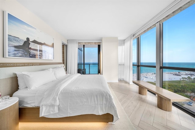 2201 Collins Ave Unit 1128, Miami Beach, FL 33139 - bedroom featuring a water view and a wall of windows