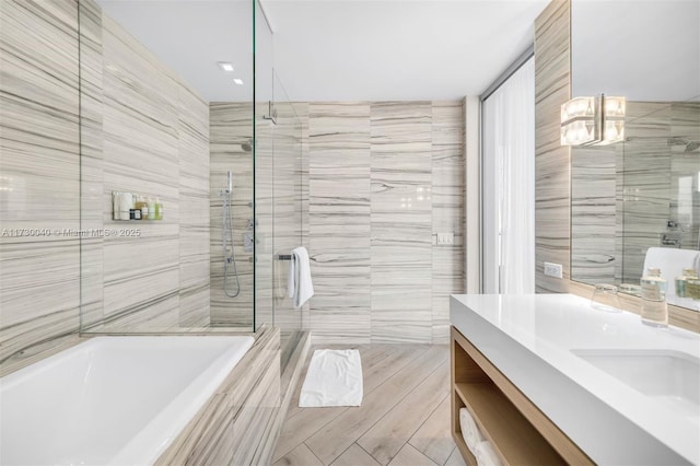 2201 Collins Ave Unit 1128, Miami Beach, FL 33139 - bathroom with tile walls, a shower stall, vanity, and a bath