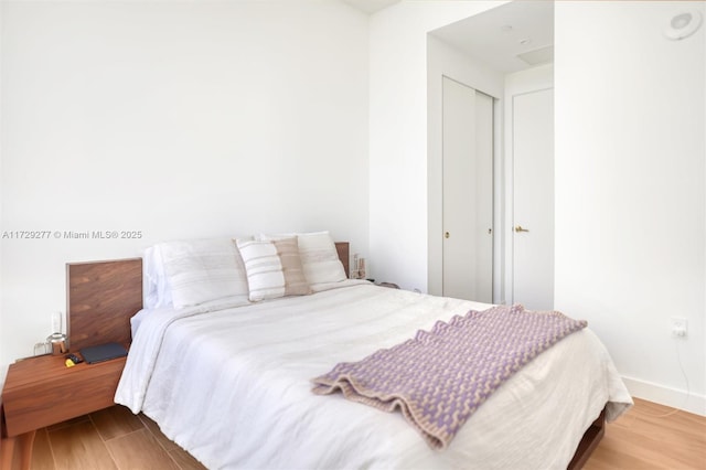 bedroom with a closet and light wood-type flooring