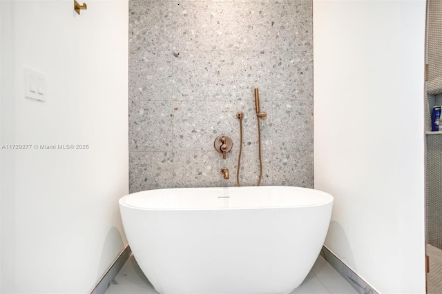 bathroom featuring tile patterned flooring and a bathing tub