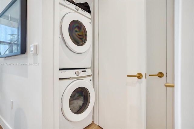 clothes washing area featuring stacked washer / drying machine