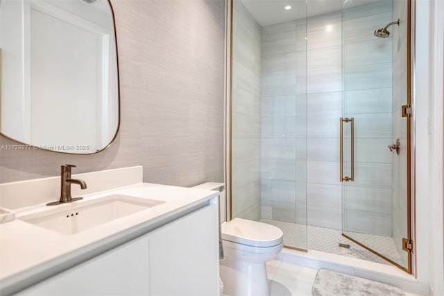 bathroom featuring vanity, toilet, and walk in shower