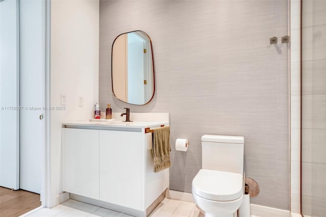 bathroom featuring vanity, tile patterned floors, and toilet