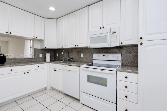 kitchen with white cabinetry, sink, and white appliances