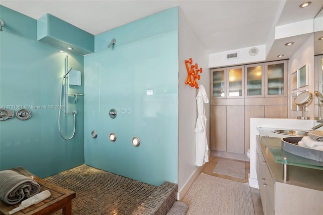 bathroom featuring vanity, tile patterned floors, and walk in shower