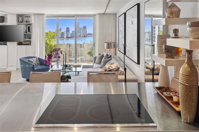 living room with a water view and floor to ceiling windows