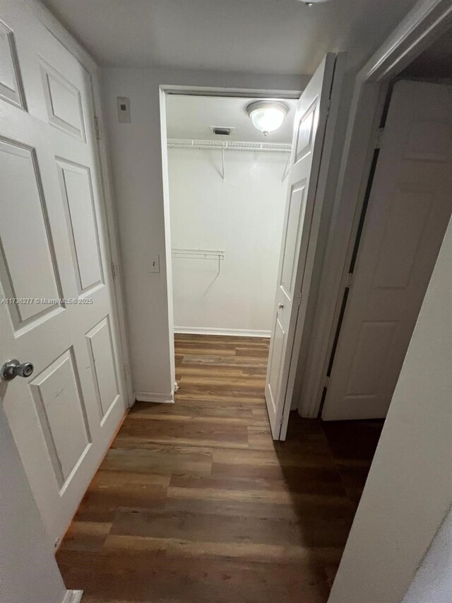 2494 Centergate Dr Unit 103, Miramar, FL 33025 - hallway featuring baseboards, visible vents, and wood finished floors