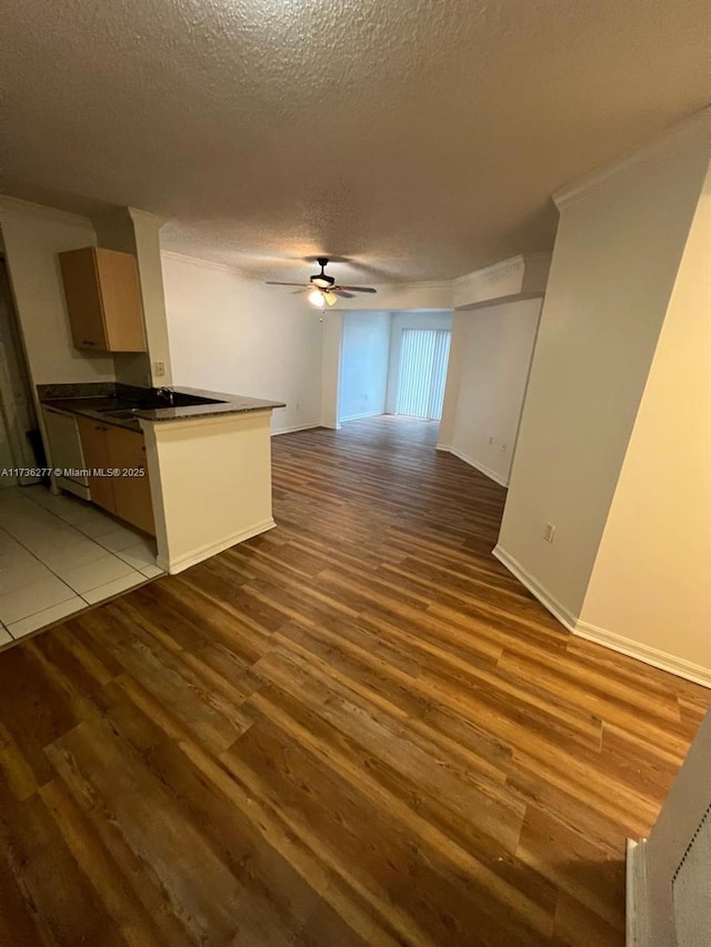 2494 Centergate Dr Unit 103, Miramar, FL 33025 - unfurnished living room featuring baseboards, a textured ceiling, wood finished floors, and a ceiling fan