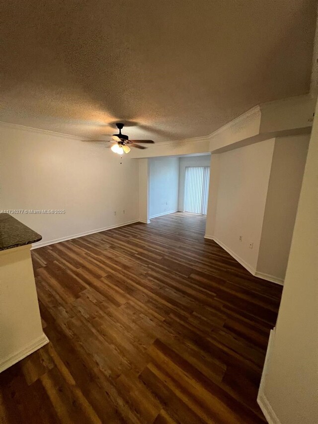 2494 Centergate Dr Unit 103, Miramar, FL 33025 - empty room featuring a textured ceiling, crown molding, baseboards, ceiling fan, and dark wood finished floors