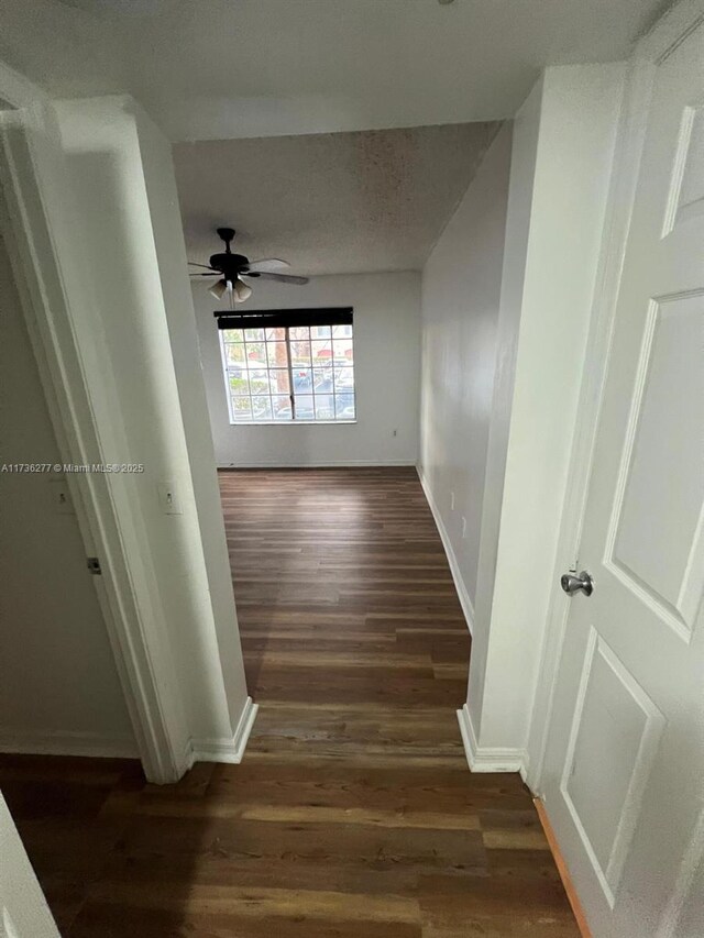 2494 Centergate Dr Unit 103, Miramar, FL 33025 - corridor featuring dark wood-style flooring, baseboards, and a textured ceiling