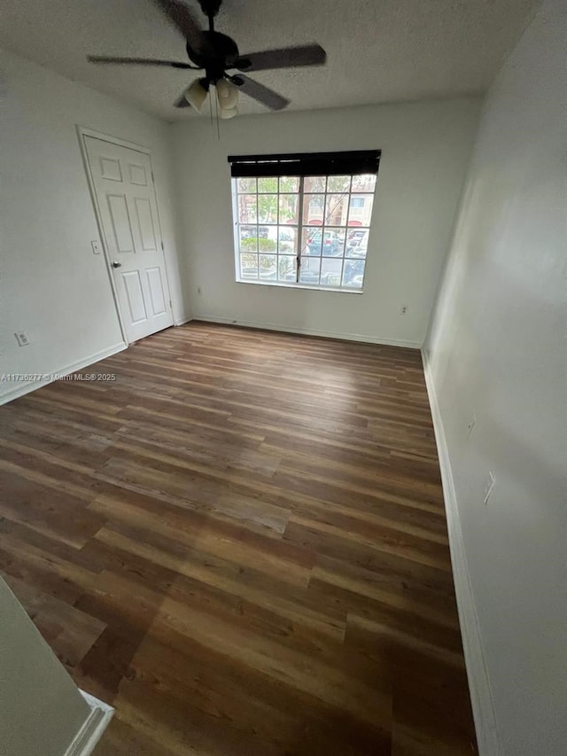 2494 Centergate Dr Unit 103, Miramar, FL 33025 - spare room featuring baseboards, wood finished floors, ceiling fan, and a textured ceiling