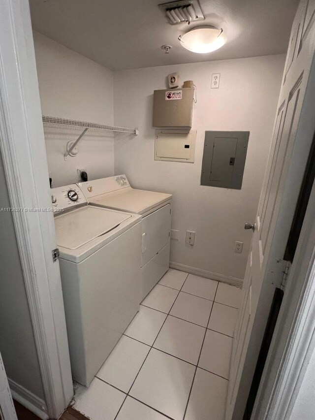 2494 Centergate Dr Unit 103, Miramar, FL 33025 - laundry room with washing machine and clothes dryer, light tile patterned flooring, visible vents, electric panel, and laundry area