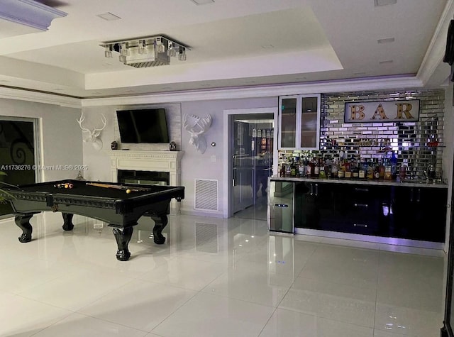 misc room featuring crown molding, billiards, a tray ceiling, and light tile patterned floors