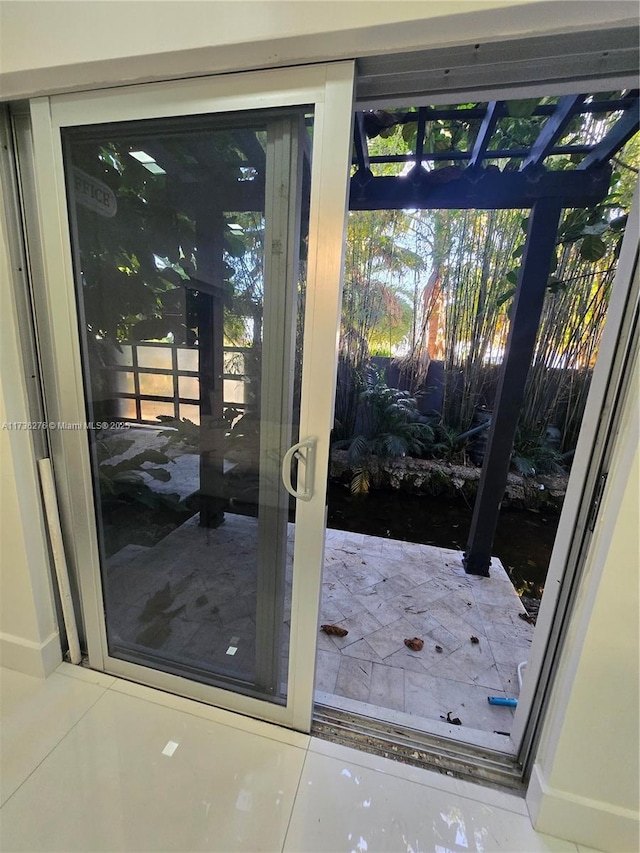 doorway with tile patterned flooring