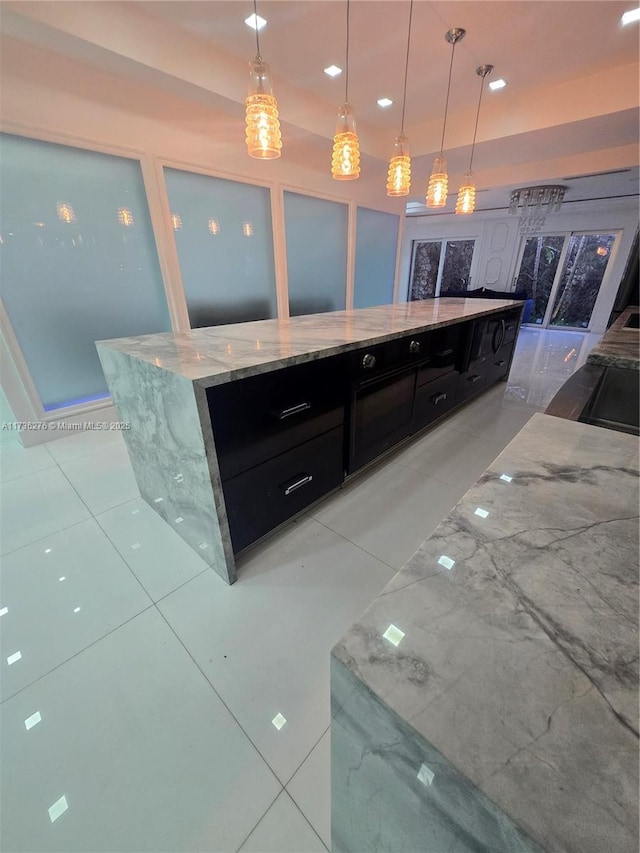 bar featuring light tile patterned flooring, light stone counters, and decorative light fixtures