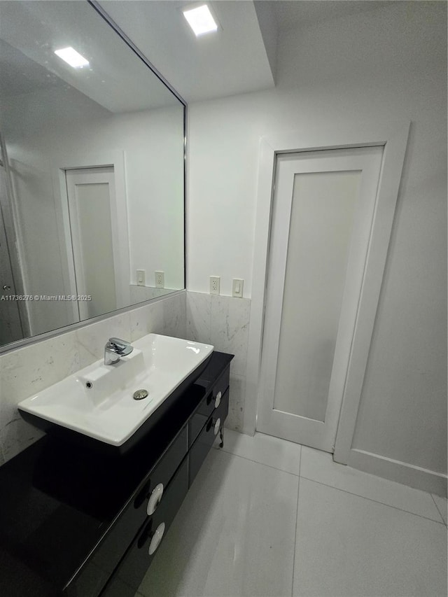 bathroom featuring vanity, tile walls, and tile patterned floors