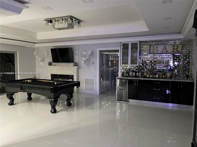 miscellaneous room with crown molding, billiards, bar, and a tray ceiling