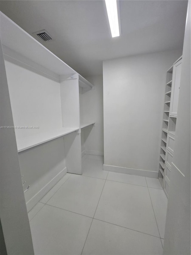 walk in closet with light tile patterned flooring